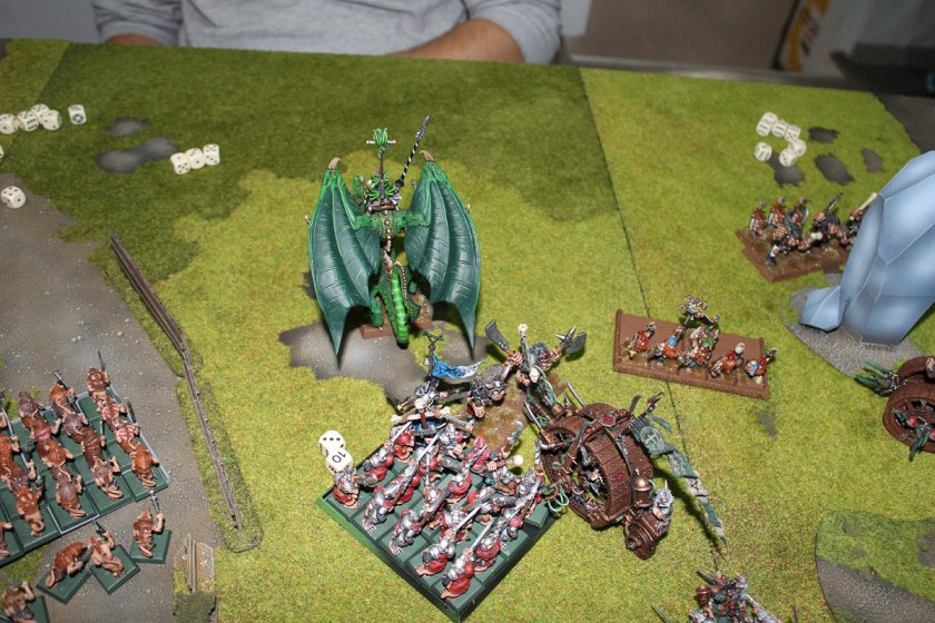 DraAsarnil was killed by Teethtoosk and broken Dragon fled from combat. Stormvermin pursued and caught the beast and charged at Ogres regiment.